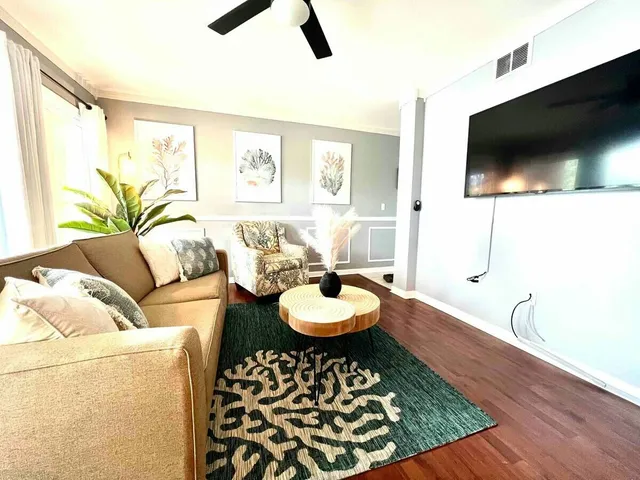 a living room with furniture and a flat screen tv