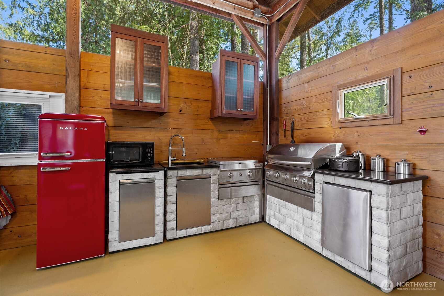271 Skate Creek Road North Ashford, WA 98304 - Photo 24 of 40 a kitchen with stainless steel appliances granite countertop a stove a sink and a refrigerator