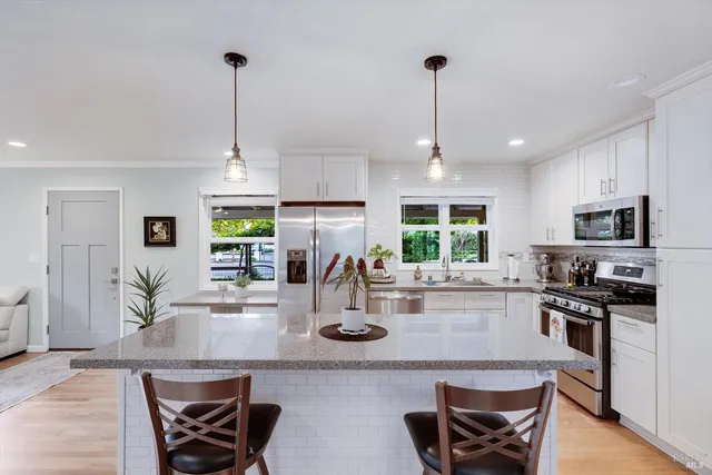 a kitchen with counter top space cabinets and appliances