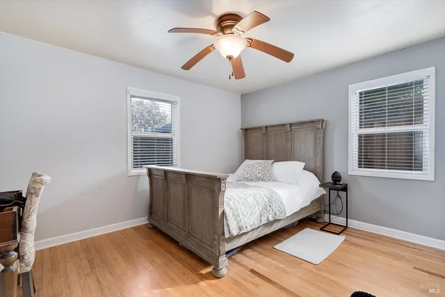 a bed sitting in a bedroom next to a window