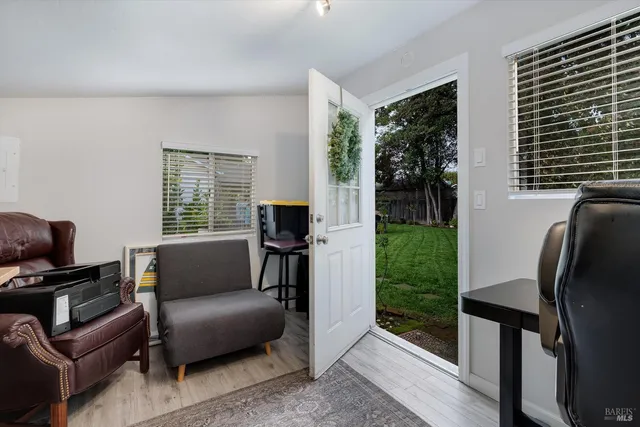 a living room with furniture tv and a window