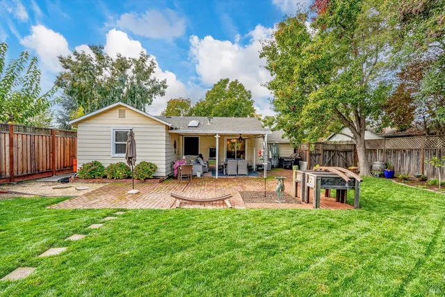 a front view of a house with a garden and patio