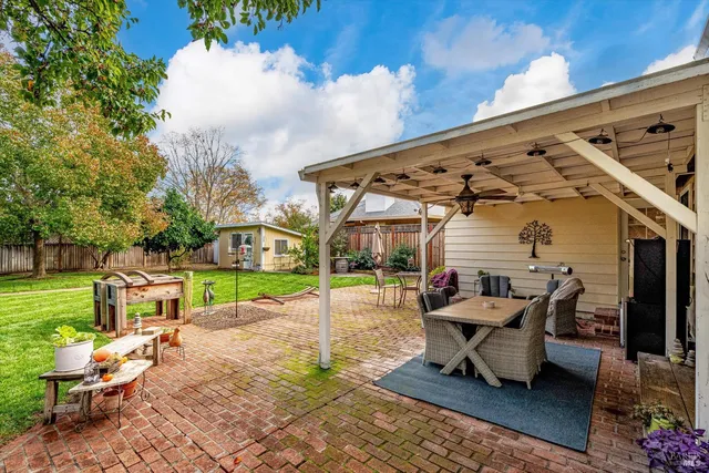 a building outdoor space with patio furniture and potted plants