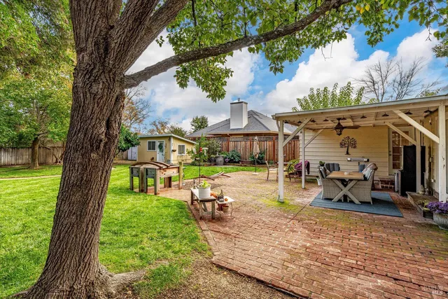 a view of a house with backyard porch and sitting area