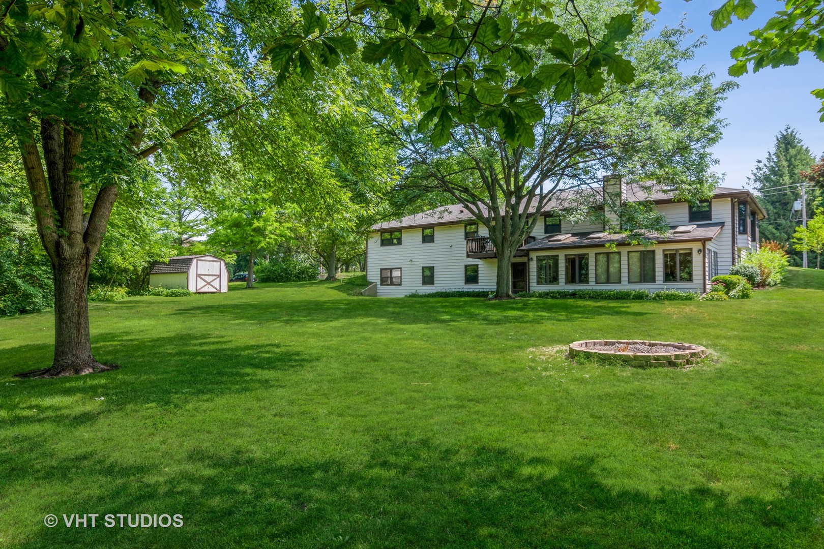 1N400 Pouley Road Elburn, IL 60119 - Photo 34 of 50 a view of a white house with a big yard and large trees