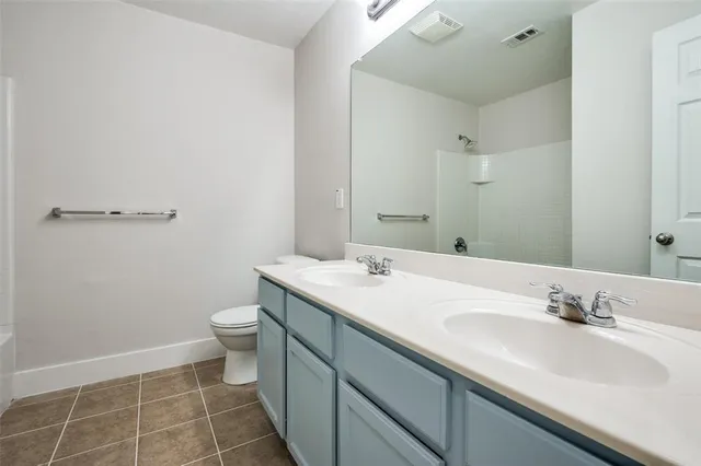 a bathroom with a sink toilet and a mirror