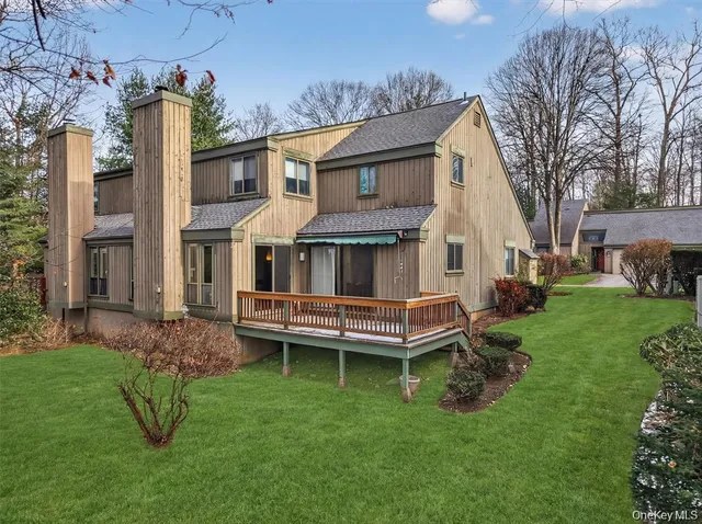 a view of a house with a yard and sitting area