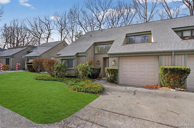a front view of a house with a garden and yard