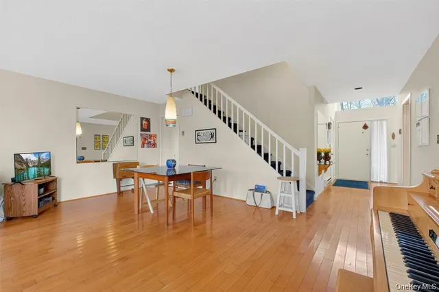 a view of a dining room with furniture and wooden floor