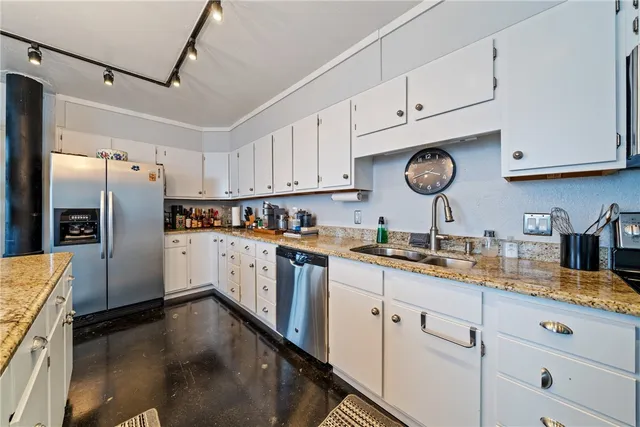 a kitchen with refrigerator cabinets and wooden floor
