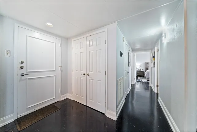 a view of a hallway with wooden floor