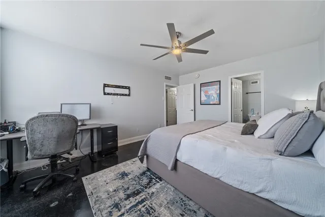 a bedroom with a bed chair and dresser