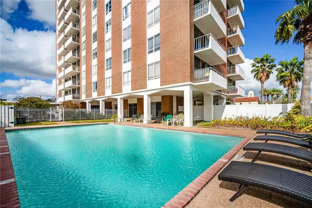 a view of an swimming pool with outdoor seating