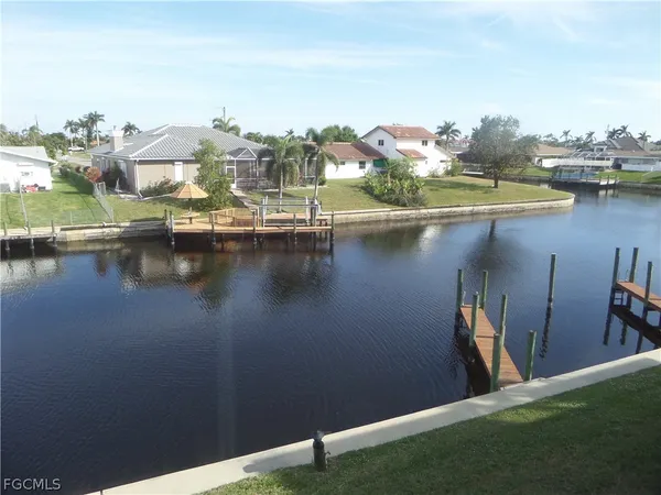 an aerial view of residential houses with outdoor space and lake view