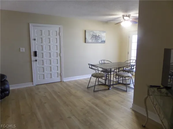 a view of a dining room with furniture window and wooden floor