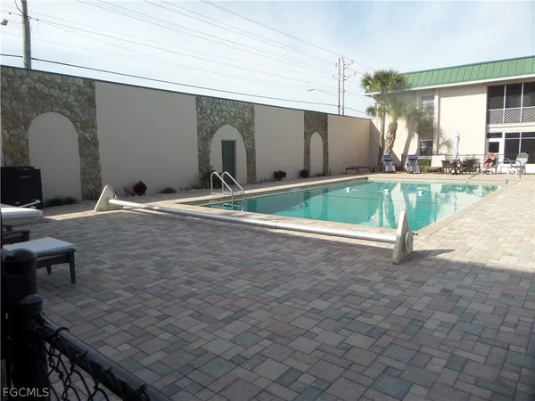 a swimming pool with outdoor seating and yard