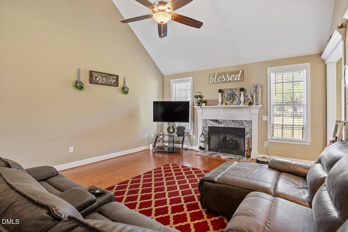 1001 Bellewood Farms Road Raleigh, NC 27603 - Photo 14 of 39 a living room with furniture a flat screen tv and a fireplace