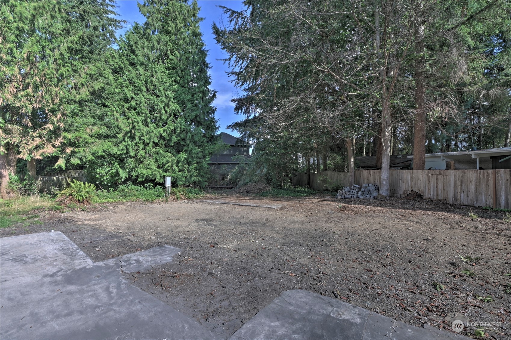 20701 34th Drive Southeast Bothell, WA 98012 - Photo 8 of 8 a view of a backyard with large trees and wooden fence