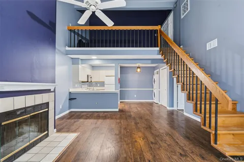 a view of staircase and kitchen with wooden floor