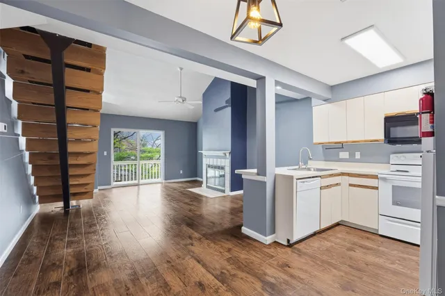 a kitchen with cabinets and white appliances