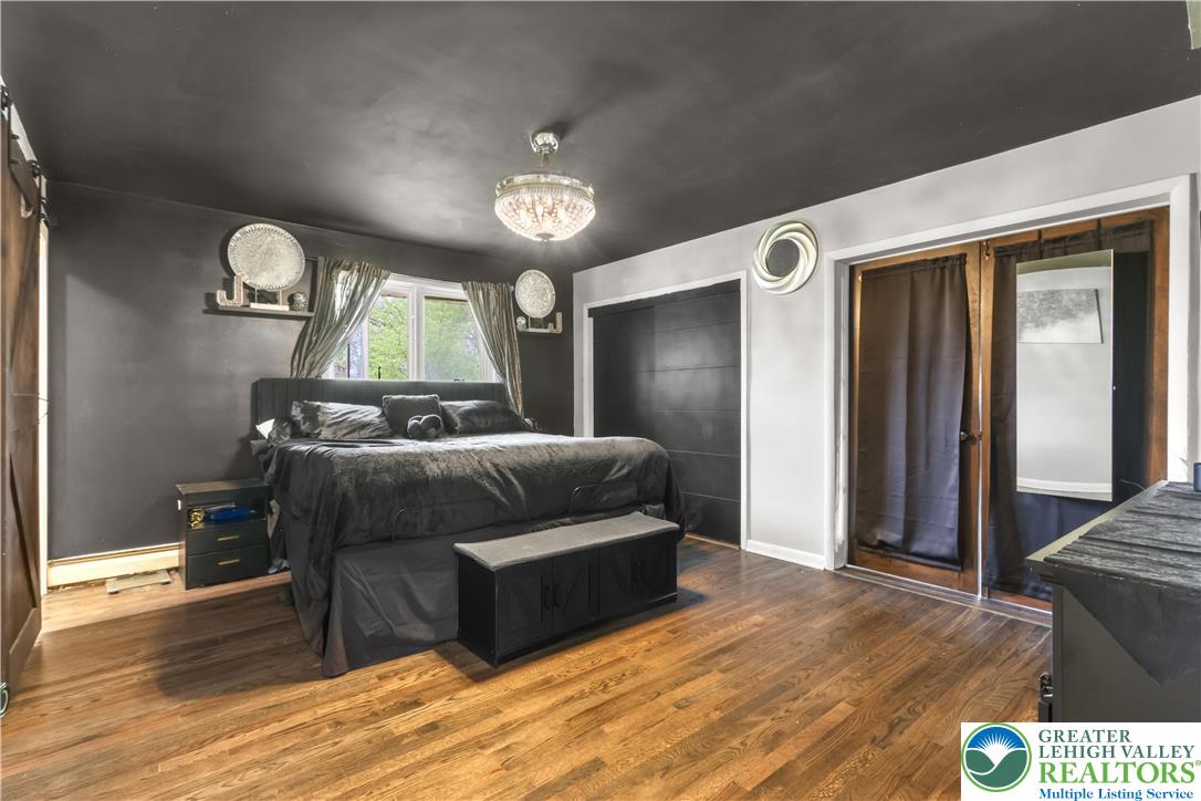 1042 Neffs Laurys Road Laurys Station, PA 18059 - Photo 19 of 27 a bedroom with a bed window and wooden floor