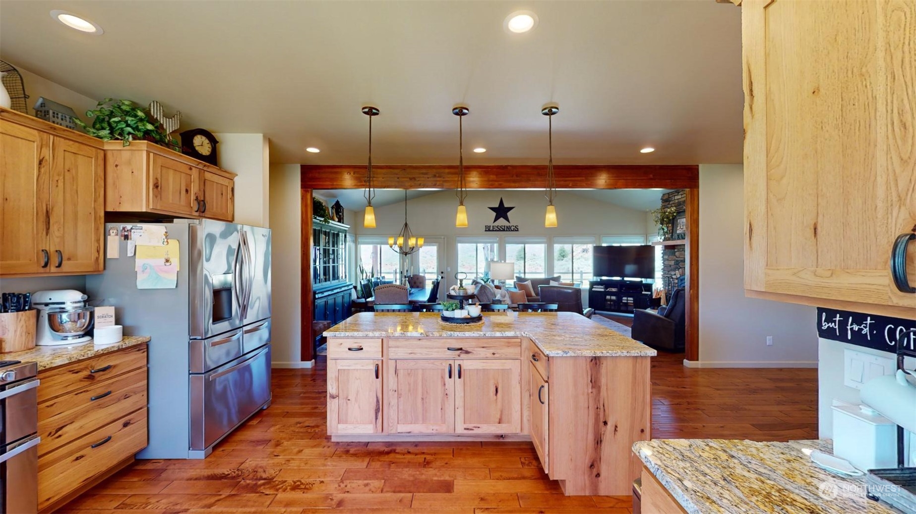 192 Hubbard Road Riverside, WA 98849 - Photo 12 of 40 a kitchen with stainless steel appliances kitchen island granite countertop a refrigerator a stove a sink and a dining table with wooden floor