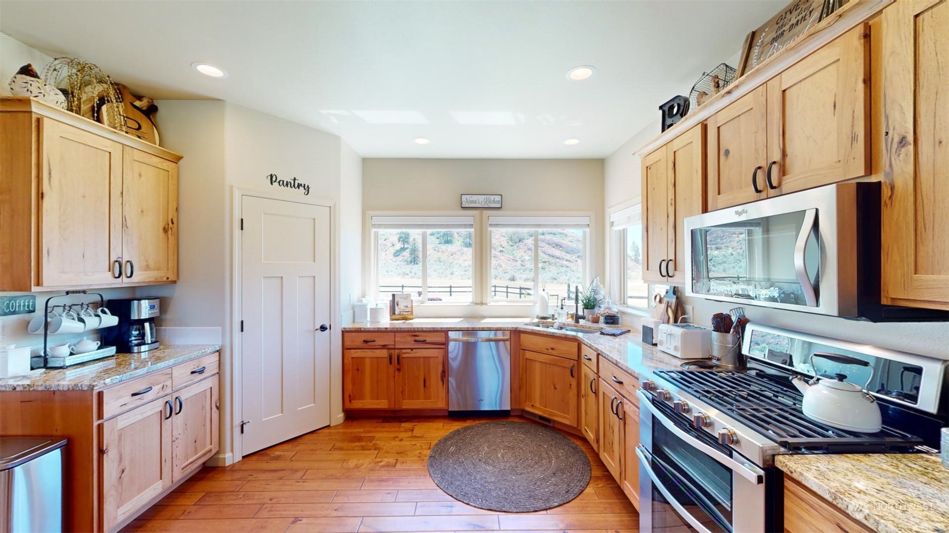 192 Hubbard Road Riverside, WA 98849 - Photo 10 of 40 a kitchen with stainless steel appliances granite countertop a stove a sink dishwasher and a refrigerator