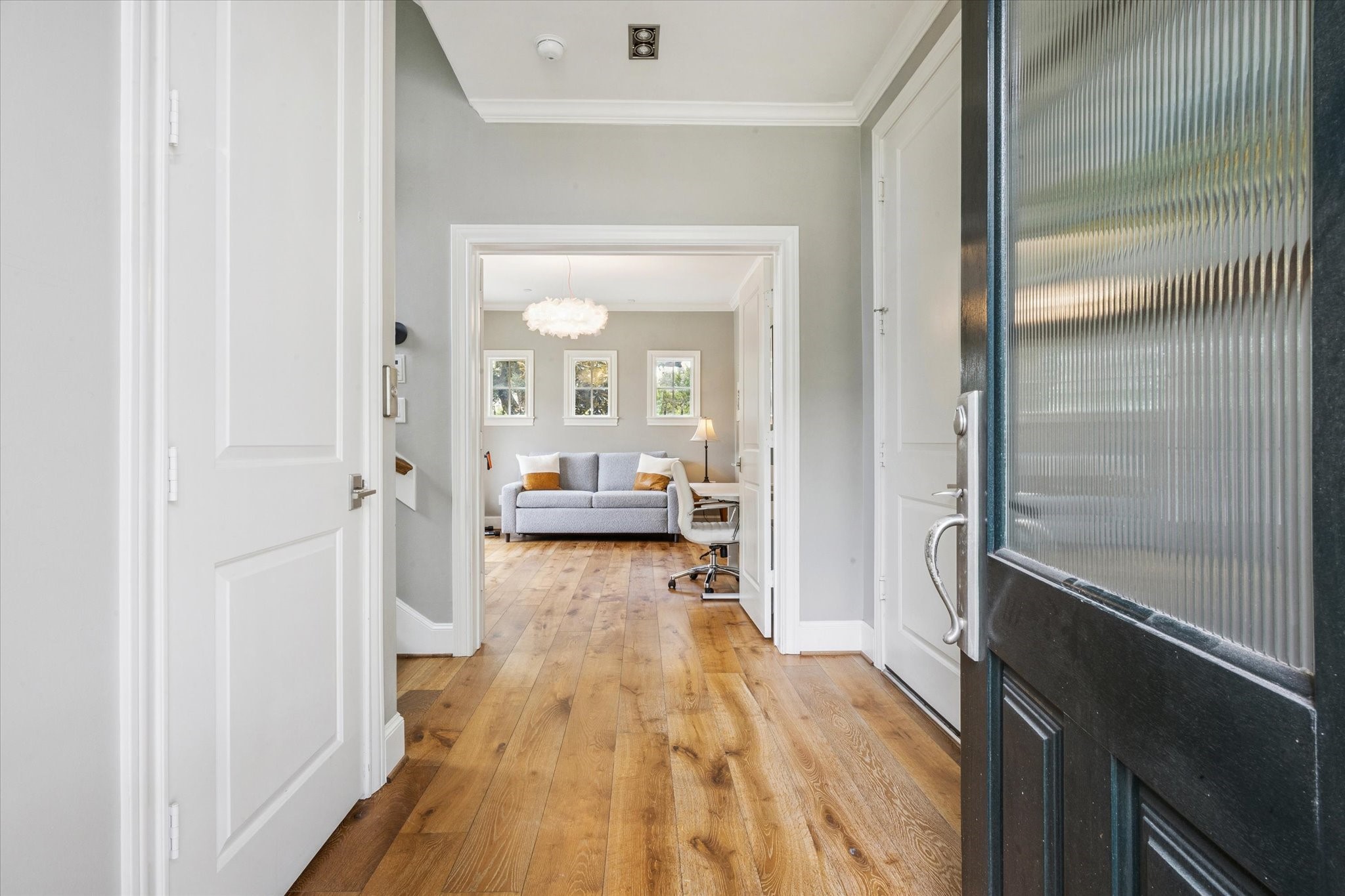 6331 Durford Street Houston, TX 77007 - Photo 5 of 37 Side view Door opens on the foyer with high ceilings, wood floors, access to garage, elevator, and the first-floor bedroom.