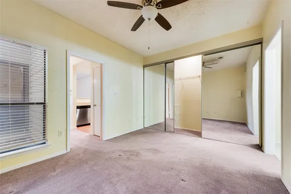 a view of empty room with ceiling fan