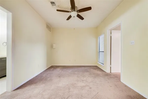 an empty room with a fireplace and a window