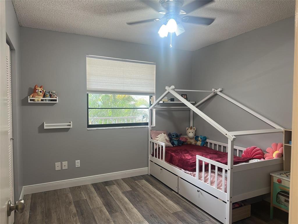 9682 West McNab Road, Unit 9682 Tamarac, FL 33321 - Photo 13 of 22 a living room with furniture and a chandelier