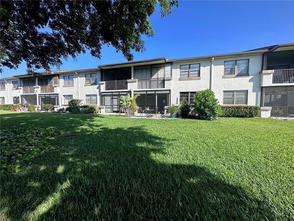 9682 West McNab Road, Unit 9682 Tamarac, FL 33321 - Photo 2 of 22 a front view of a house with a yard