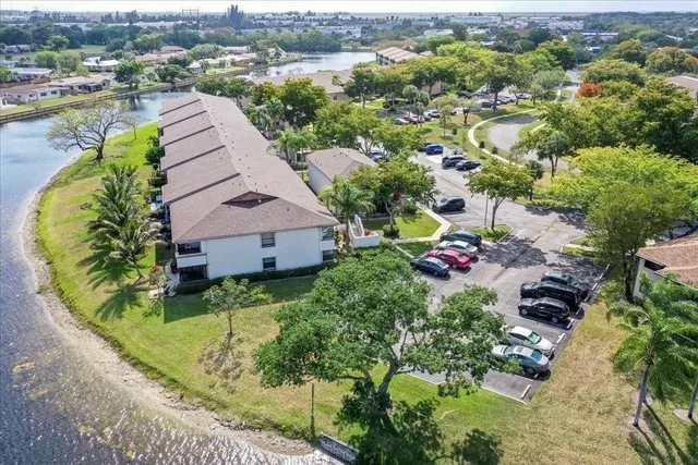 an aerial view of a house with a yard and lake view