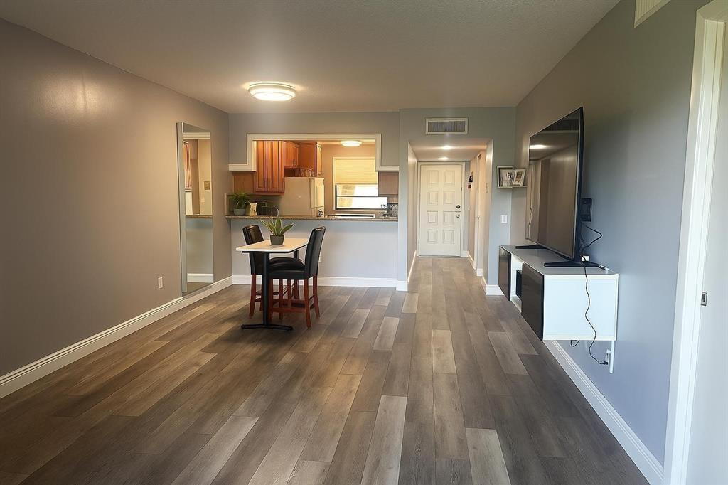 9682 West McNab Road, Unit 9682 Tamarac, FL 33321 - Photo 3 of 22 a dining room with furniture and wooden floor