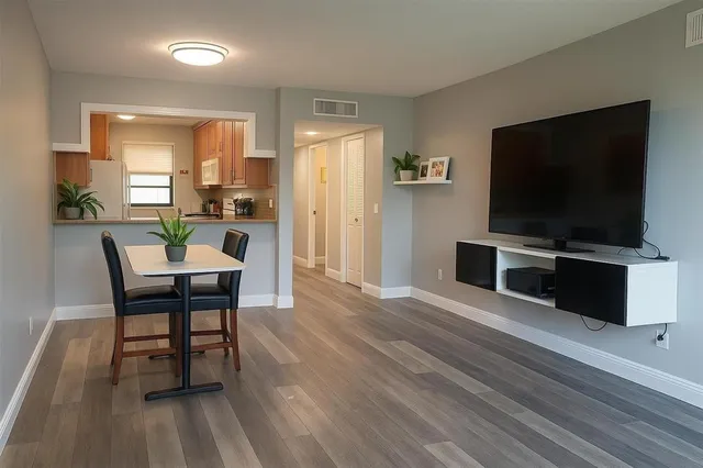 a view of a dining room with furniture window and wooden floor