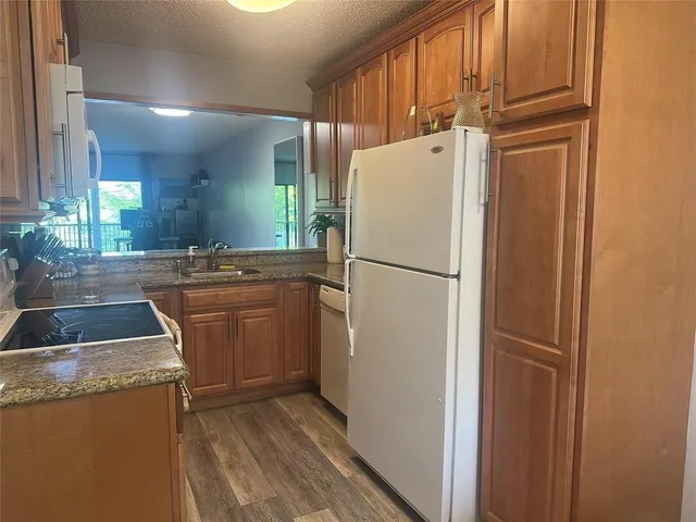 a kitchen with a refrigerator a sink and dishwasher