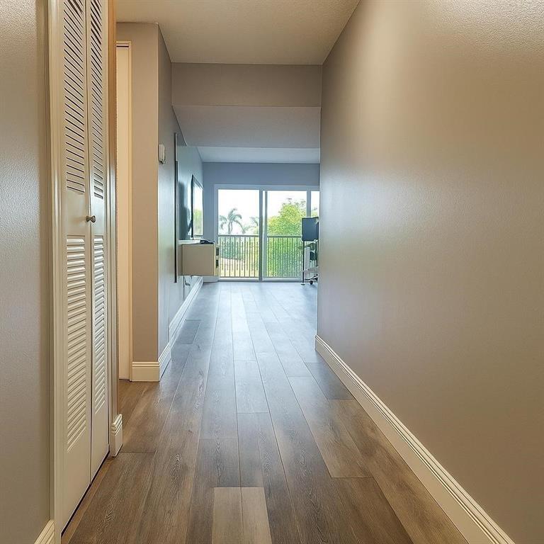 9682 West McNab Road, Unit 9682 Tamarac, FL 33321 - Photo 7 of 22 a view of a hallway with wooden floor and stairs