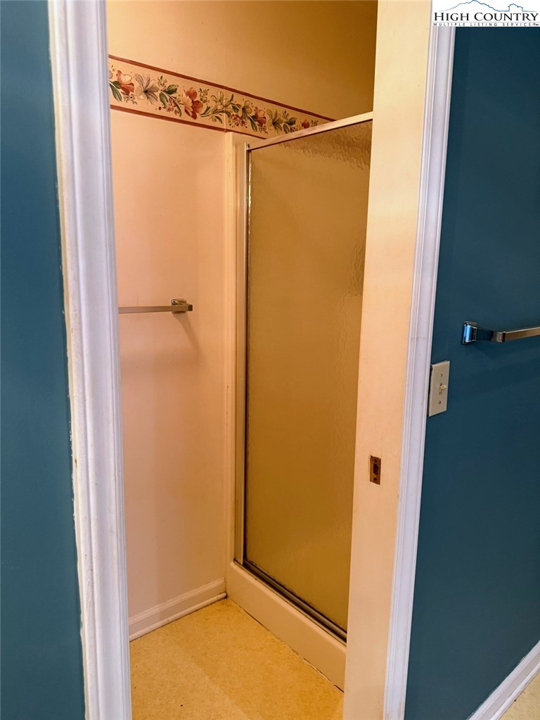 651 Rivers Edge Road Sparta, NC 28675 - Photo 22 of 36 a bathroom with a glass shower door