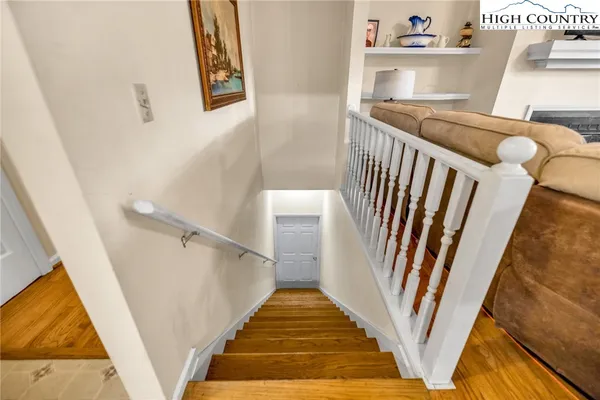 a view of a lake with a yard and large trees