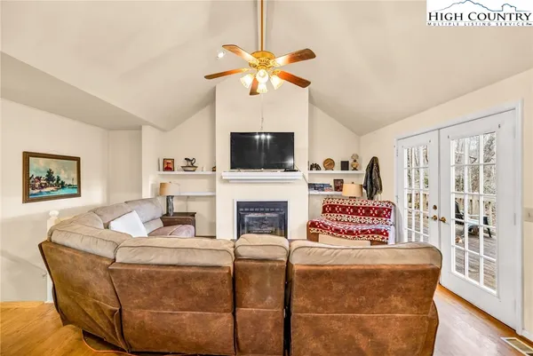 a living room with furniture a fireplace and a flat screen tv