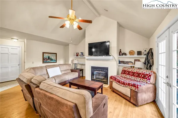 a living room with furniture a fireplace and a flat screen tv