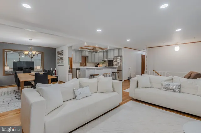 a living room with fireplace furniture and a large window