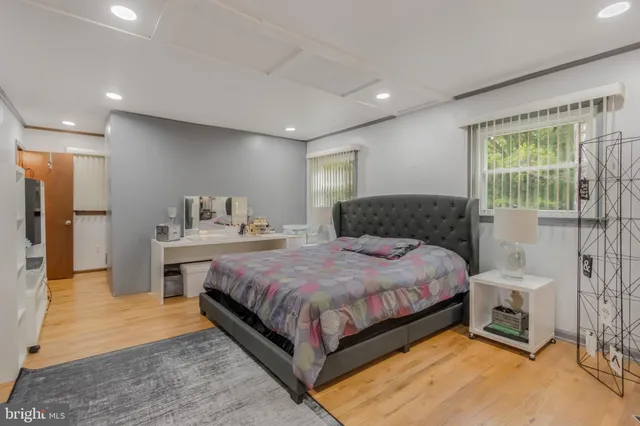 a spacious bedroom with a large bed and a chandelier