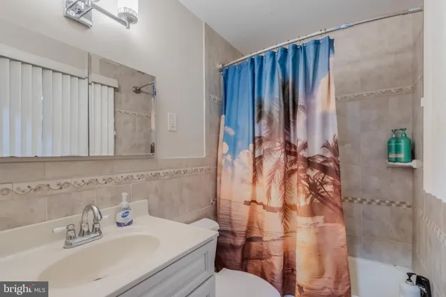 a bathroom with a granite countertop double vanity sink and a mirror