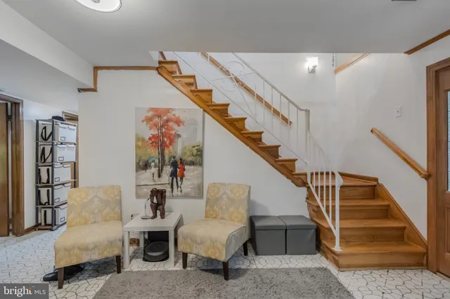 a living room with furniture and floor to ceiling windows