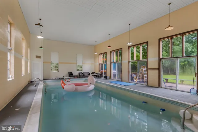 a backyard of a house with swimming pool and trees