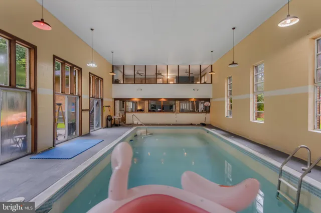 a view of a swimming pool with an outdoor space and seating area