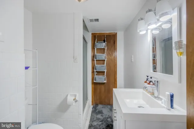 a view of a backyard with plants and large trees