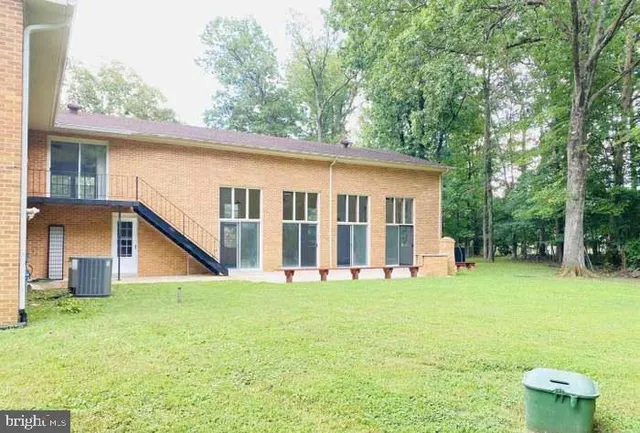 a view of backyard of house with green space