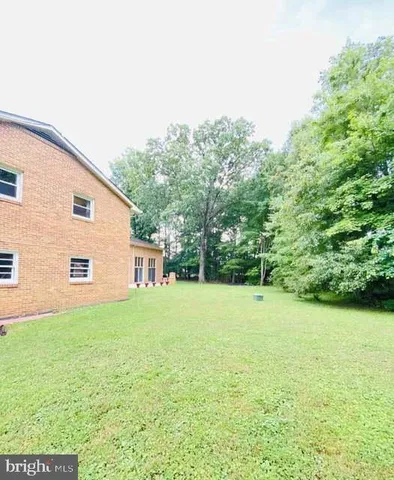 a living room with a bed furniture and a wooden floor